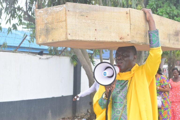 ‘God not happy with Buhari govt’ – Nigerian pastor carries coffin in protest